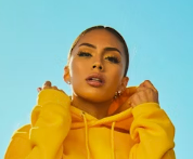 Woman in yellow hoodie posing